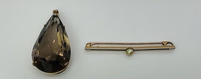 Lot 758 - A large smoky quartz pear shaped pendant in...