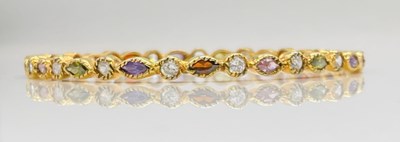 Lot 724 - An unusual yellow metal simulated gem set...