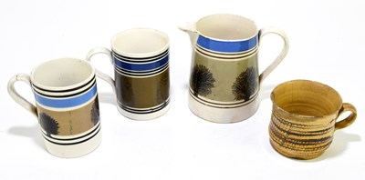 Lot 560 - MOCHAWARE; a mochaware jug and two mugs,...