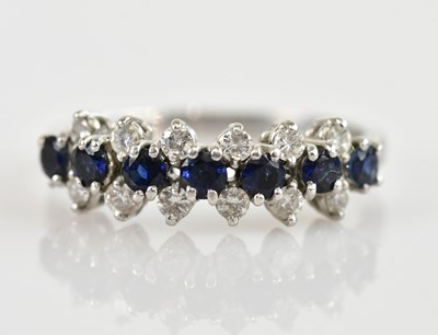 Lot 2471 - An 18ct white gold diamond and sapphire set...
