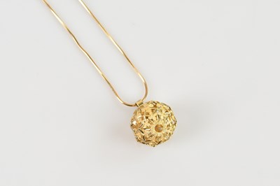 Lot 2190 - A 9ct yellow textured gold orb pendant,...