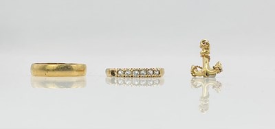 Lot 749 - A 9ct yellow gold wedding band, size N, a 9ct...