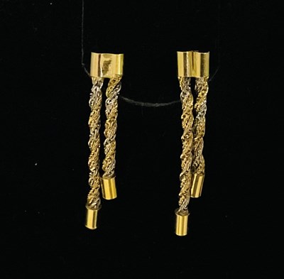 Lot 776 - A pair of two-tone double tassel drop earrings,...