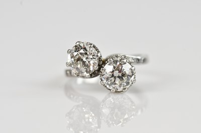 Lot 2242 - An 18ct white gold diamond set crossover ring,...