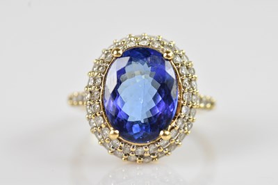 Lot 2311 - An 18ct yellow gold diamond and tanzanite...