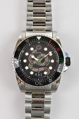 Lot 1 - GUCCI; a boxed dive watch with black dial...