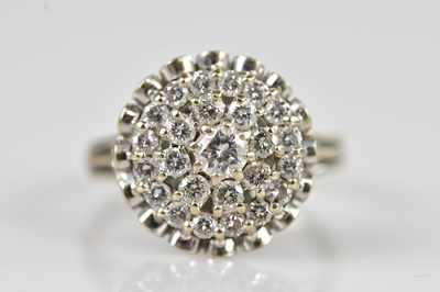 Lot 2310 - A white metal diamond set cluster ring, size T,...