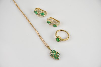 Lot 2507 - A yellow metal diamond and emerald set cluster...