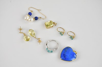 Lot 2557 - A white metal dress ring set with pale blue...