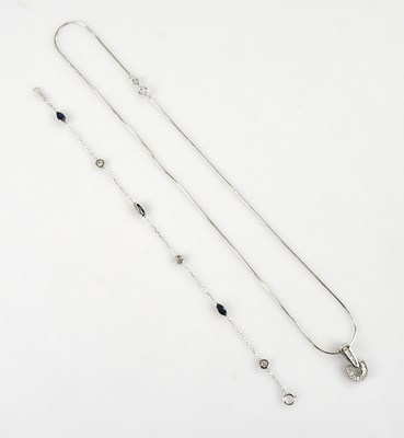 Lot 2182 - A white metal diamond set articulated pendant,...