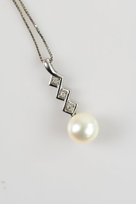 Lot 2194 - A white metal diamond and pearl set pendant,...