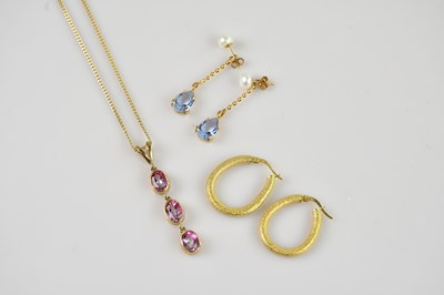 Lot 2208 - A 9ct yellow gold drop pendant set with three...