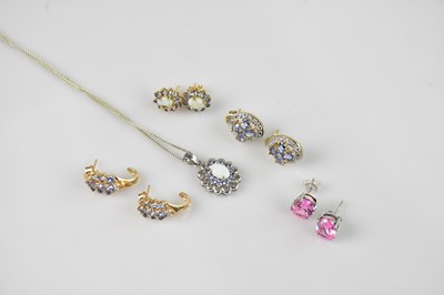 Lot 2184 - A 9ct white gold pendant with central opal and...