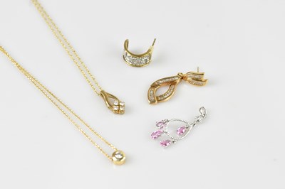 Lot 2187 - Two 9ct yellow gold diamond set pendants...