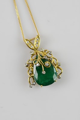 Lot 2024 - A yellow metal diamond and emerald set pendant,...
