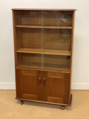 Lot 940 - PRIORY FURNITURE; an oak glazed bookcase over...