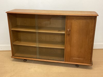 Lot 941 - PRIORY FURNITURE; an oak glazed bookcase with...