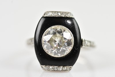 Lot 2253 - An Art Deco diamond and onyx set solitaire...