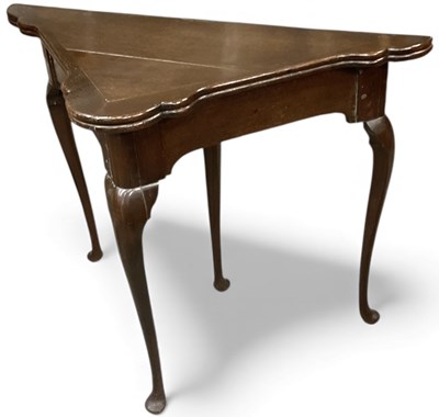 Lot 110 - A 19th century oak triangular card table with...