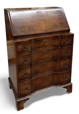 Lot 99 - A 1930s burr walnut serpentine fronted bureau...