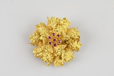 Lot 1265A - A yellow metal floral effect textured brooch...