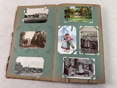 Lot 471 - POSTCARDS; a postcard album comprising...