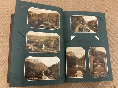 Lot 472 - POSTCARDS; a postcard album containing...