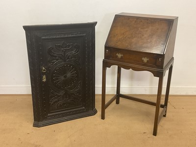 Lot 956 - An oak corner cupboard with intricately carved...