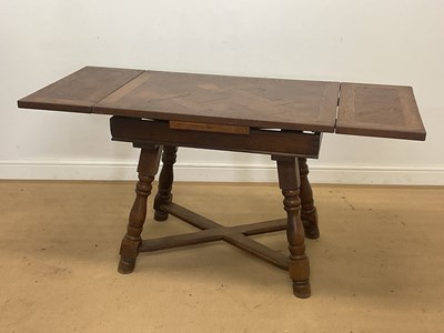 Lot 962 - An oak draw-leaf table with turned legs and...