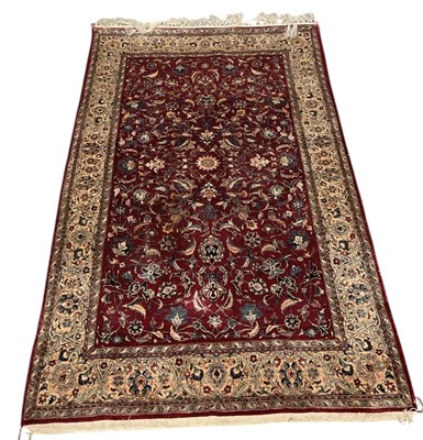 Lot 128 - A Persian style hand woven silk red ground...