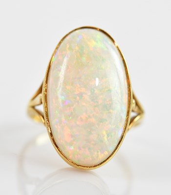 Lot 631 - An 18ct yellow gold opal set dress ring, size...