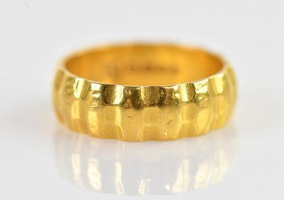 Lot 626 - A 22ct yellow gold wedding band, size M,...