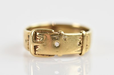 Lot 681 - A 9ct yellow gold ring in the style of a belt,...