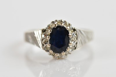 Lot 630 - An 18ct white gold and diamond ring with...