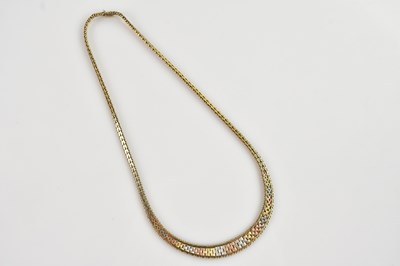 Lot 599 - A 9ct three-tone gold flat link necklace,...