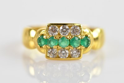 Lot 637 - An 18ct yellow gold ring set with coloured...