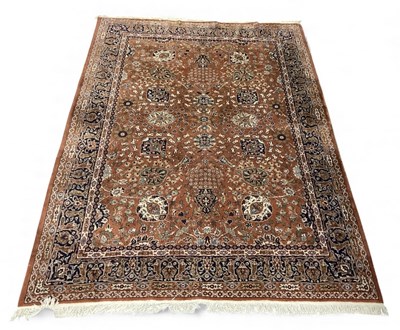 Lot 120 - A large modern red ground Persian style carpet,...