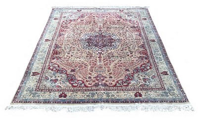 Lot 124 - A large Persian silk cream ground carpet, with...