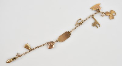 Lot 588 - A 9ct yellow gold charm bracelet with various...