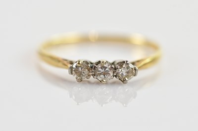 Lot 677 - A 9ct yellow gold three stone diamond ring,...