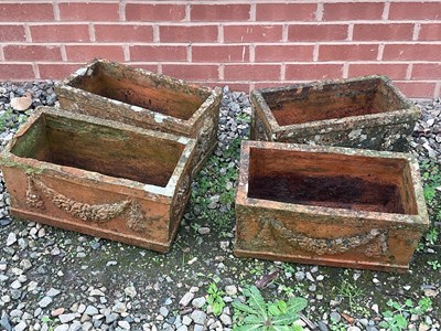 Lot 856 - Four terracotta troughs decorated with raised...