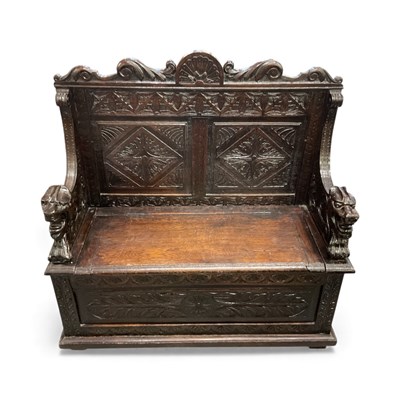 Lot 37 - An early 20th century profusely carved settle,...