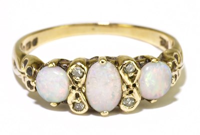 Lot 132 - A 9ct yellow gold opal and diamond chip dress...