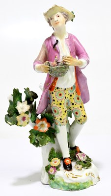 Lot 656 - An 18th century porcelain figure of a country...