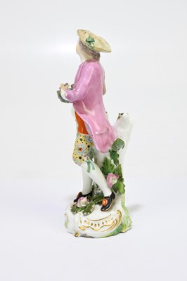 Lot 656 - An 18th century porcelain figure of a country...