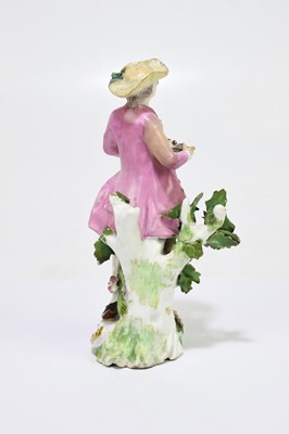 Lot 656 - An 18th century porcelain figure of a country...