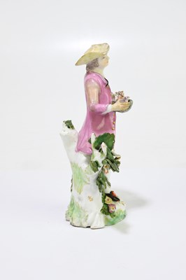 Lot 656 - An 18th century porcelain figure of a country...