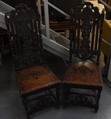 Lot 70 - A pair of Victorian carved oak hall chairs...