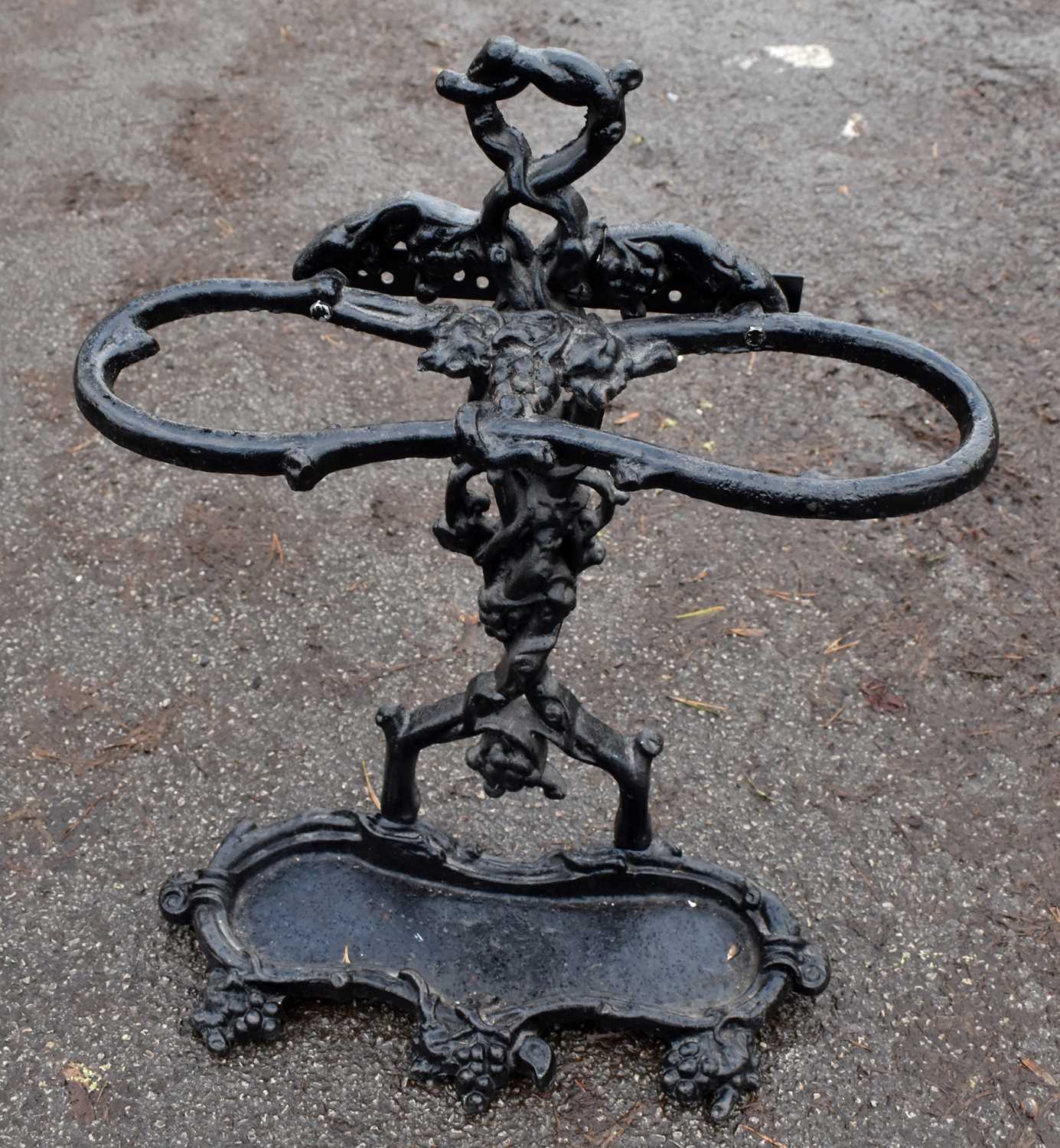 Lot 1552 A black painted cast iron stick stand