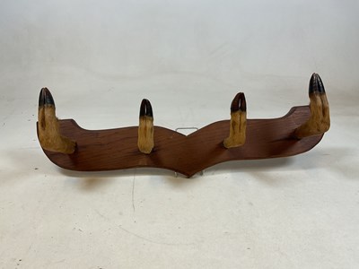 Lot 101 - A coat rack fashioned from 4 deer hooves